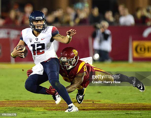 Anu Solomon of the Arizona Wildcats avoids a tackle from Su'a Cravens of the USC Trojans during the first quarter Los Angeles Coliseum on November 7,...