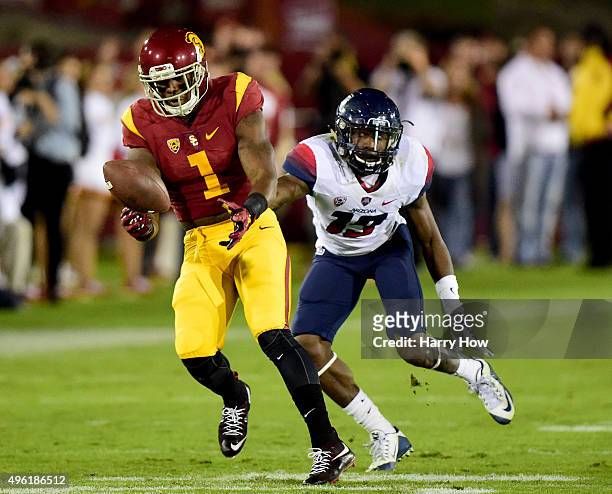 Darreus Rogers of the USC Trojans drops a pass in front of Devin Holiday of the Arizona Wildcats during the first quarter at Los Angeles Coliseum on...