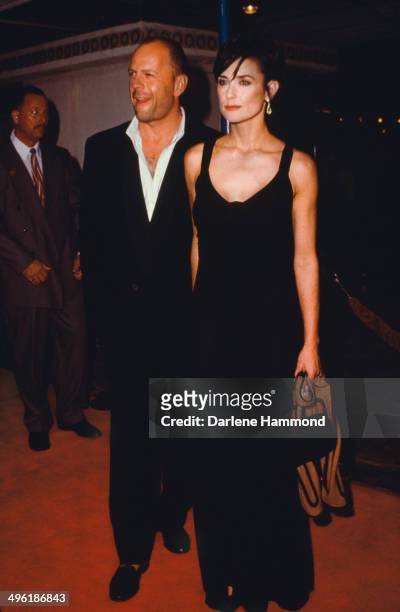 American actress Demi Moore arrives with her husband, actor Bruce Willis, at the premiere of Ridley Scott's action film 'G.I. Jane', at the Fox...