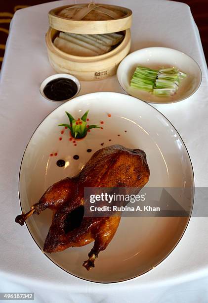 Roasted Beijing Duck, with scallions, marinated cucumber, pancakes and plum sauce prepared by Chinese Barbeque Chef Xu De Qian at the hotel's...