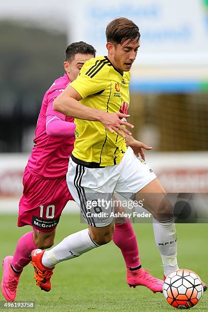 Alex Rodriguez of the Phoenix runs the ball ahead of Nick Montgomery of the Mariners during the round five A-League match between the Central Coast...