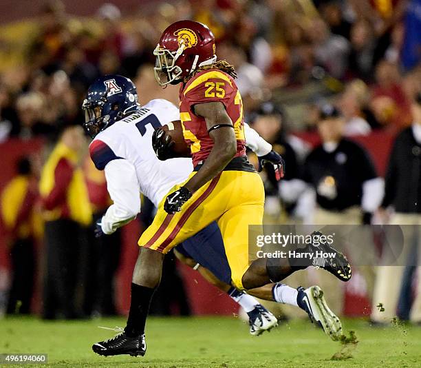 Ronald Jones II of the USC Trojans runs 74 yards for a touchdown past Marquis Ware of the Arizona Wildcats during the fourth quarter at Los Angeles...