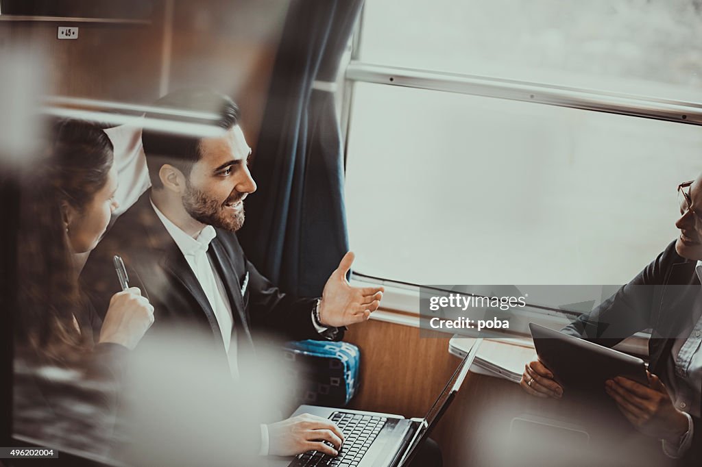 Business people during a train journey, working