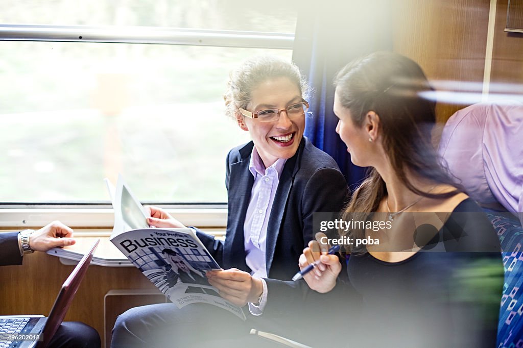 Business people during a train journey, working