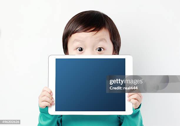 boy with tablet - child tablet stock pictures, royalty-free photos & images