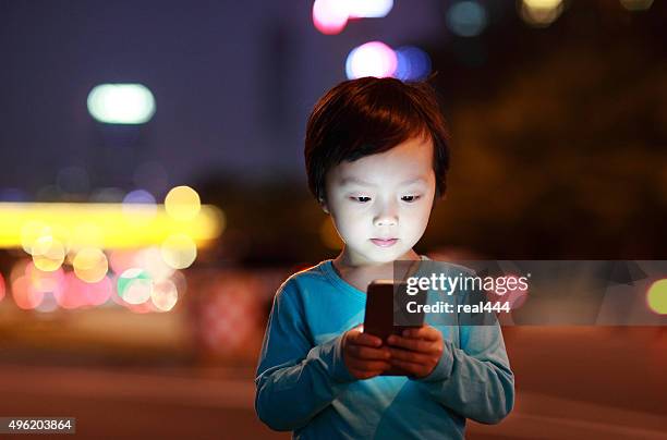 boy using smart phone - child using a smartphone stock pictures, royalty-free photos & images