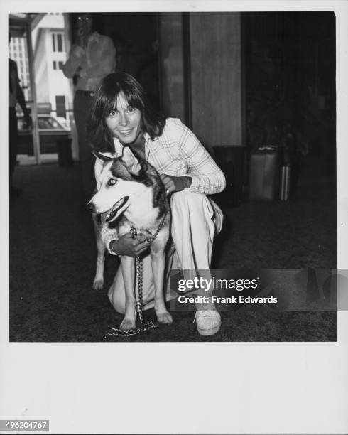 Actress Kate Jackson posing with her Siberian husky, Catcher, attending the ABC Television reception, July 1976.