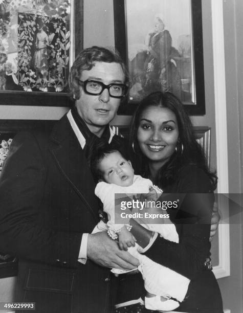 Actor Michael Caine posing with his wife Shakira and baby daughter Natasha, London, September 26th 1973.