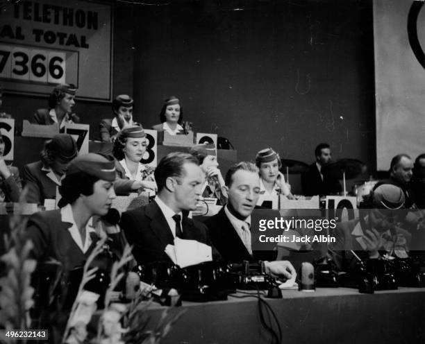 Actor Bing Crosby and entertainer Bob Hope taking part in a live telethon, to raise funds for the US Olympic Team, 1952.
