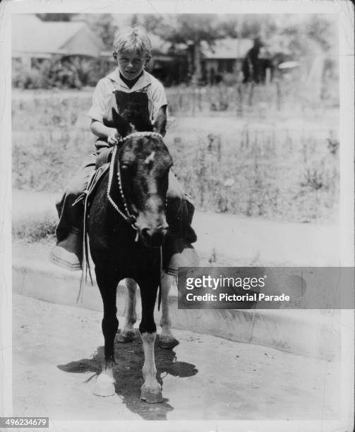 Actor William Holden as an 8 year old child, riding a horse in Monrovia, California, 1926.