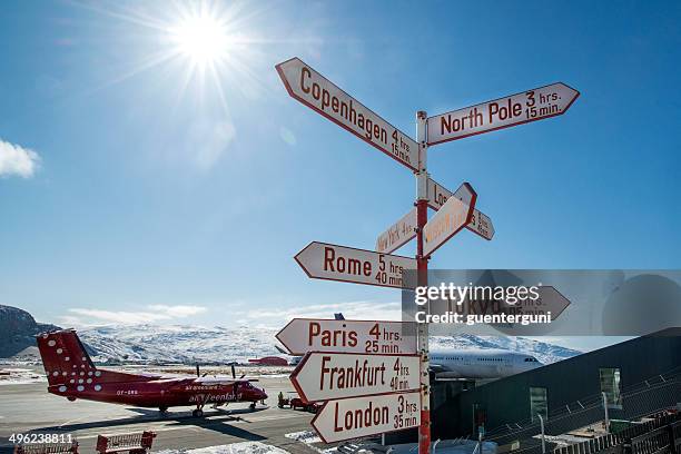 signpost at the airport of kangerlussuaq in western greenland - kangerlussuaq stock pictures, royalty-free photos & images