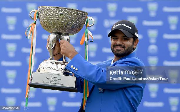 Chiragh Kumar of India with the winner's trophy during round four of the Panasonic Open India at Delhi Golf Club on November 8, 2015 in New Delhi,...
