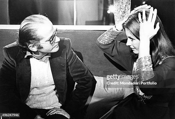 Italian singer-songwriter Gino Paoli looking at the Italian TV presenter Gabriella Farinon. January, 1973