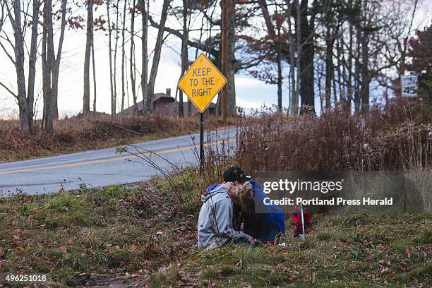 Kara Buzynski holds her brother Nate Buzynski after they place flowers on a memorial for Angel Greene, who passed away after a fatal car accident on...