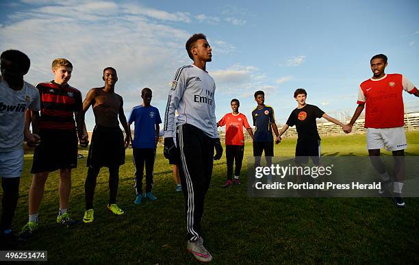 Co-Captain Abdi Shariff-Hassan talks with his teammates during practice Thursday, November 5, 2015.