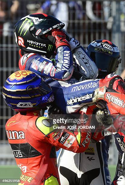 Movistar Yamaha MotoGP's Spanish rider Jorge Lorenzo is carried by others to celebrate his fifth world championships after the MotoGP motorcycling...