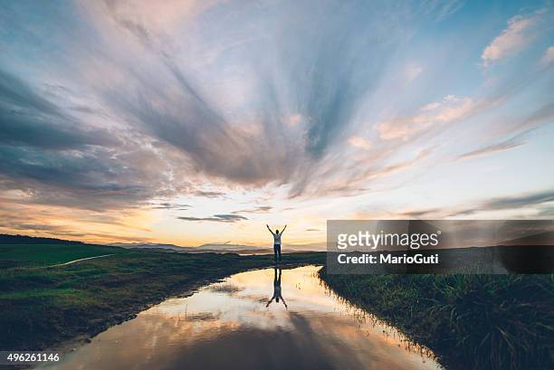 young man at sunset - religion stockfoto's en -beelden