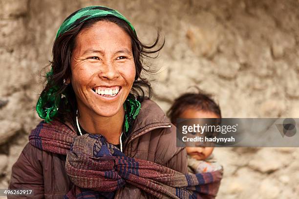 tibetan mother carrying her child - nepal stock pictures, royalty-free photos & images