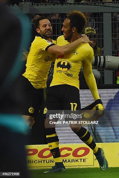 Dortmund's Gabonese striker Pierre-Emerick Aubameyang celebrates scoring with his team-mate midfielder Gonzalo Castro, showing his Batman shirt...