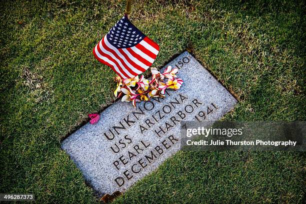 United States Flag and Hawaiian Flower Lei Adorn the Grave Site of an Unknown that Died on December 7, 1941 at Pearl Harbor on the USS Arizona at the...