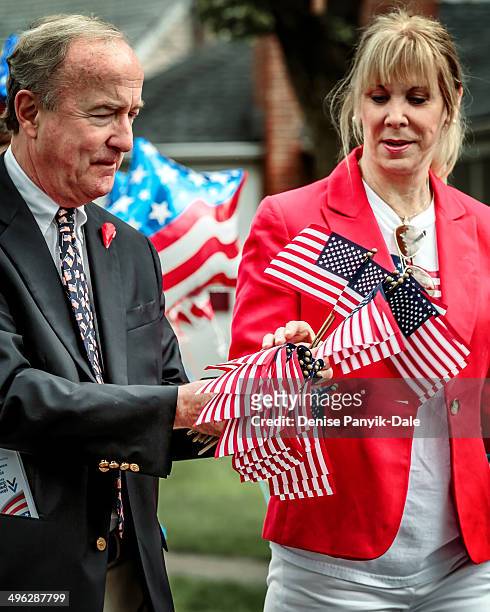 Local politicians with small flags during Memorial Day parade