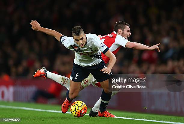 Erik Lamela of Spurs holds off Mathieu Debuchy of Arsenal during the Barclays Premier League match between Arsenal and Tottenham Hotspur at the...