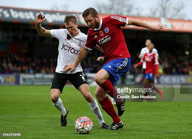 Richard Brodie of Aldershot holds off the challenge of Stephen Darby of Bradford during The Emirates FA Cup First Round match between Aldershot Town...