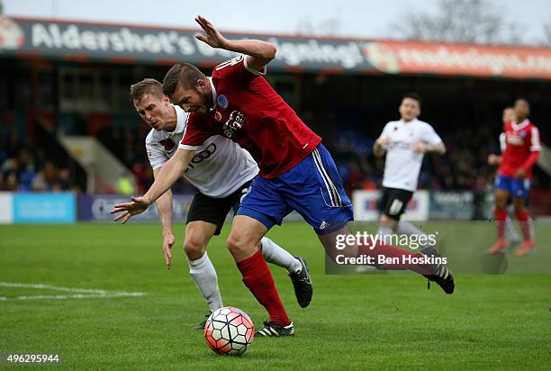 Richard Brodie of Aldershot holds off the challenge of Stephen Darby of Bradford during The Emirates FA Cup First Round match between Aldershot Town...