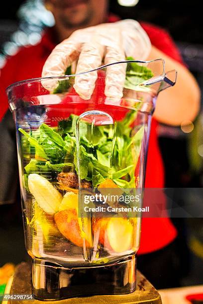 The staff at a stand of the Keimling Naturkost GmbH fills a mixer with vegetables and fruits during a demonstration at the Veggie World 2015 Vegan...