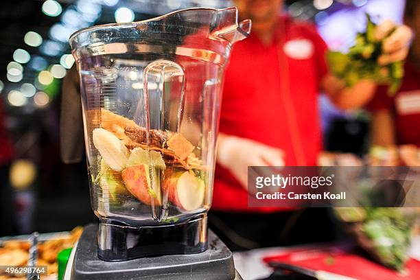 The staff at a stand of the Keimling Naturkost GmbH fills a mixer with vegetables and fruits during a demonstration at the Veggie World 2015 Vegan...