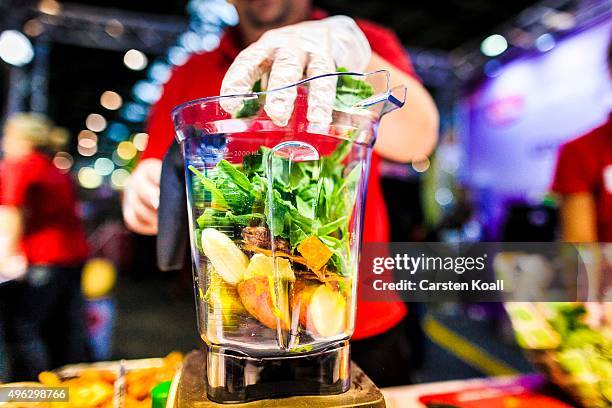 The staff at a stand of the Keimling Naturkost GmbH fills a mixer with vegetables and fruits during a demonstration at the Veggie World 2015 Vegan...