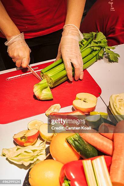 The staff at a stand of the Keimling Naturkost GmbH chop celery during a demonstration at the Veggie World 2015 Vegan Trade Fair on November 8, 2015...