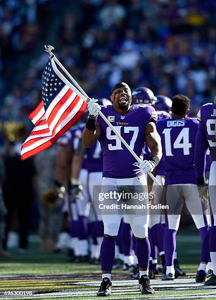 Everson Griffen of the Minnesota Vikings waves a flag before the game against the St. Louis Rams on November 8, 2015 at TCF Bank Stadium in...