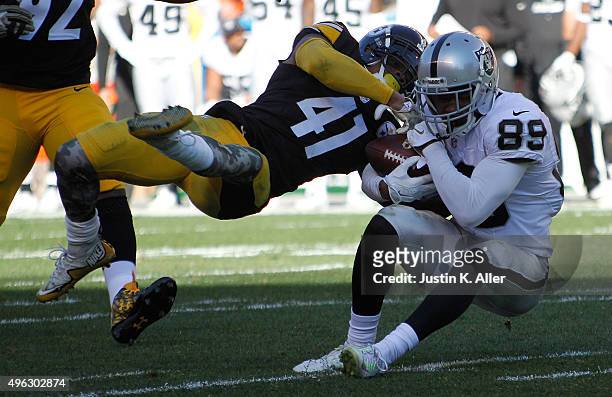 Antwon Blake of the Pittsburgh Steelers attempts to break up a play as Amari Cooper of the Oakland Raiders catches a pass during the game at Heinz...