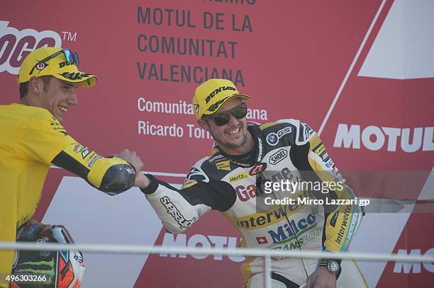 Alex Rins of Spain and Pagina Amarillas HP40 celebrates with Thomas Luthi of Switzerland and Derendinger Racing Interwetten on the podium at the end...
