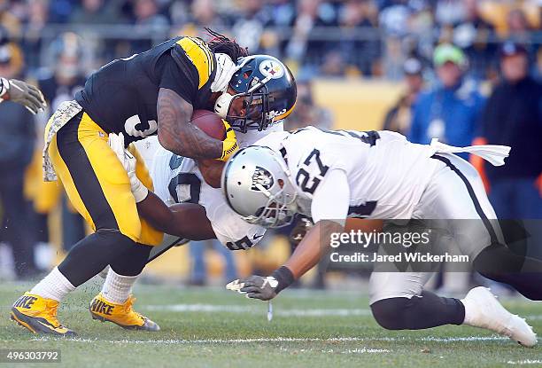 Taylor Mays of the Oakland Raiders tackles DeAngelo Williams during the 2nd quarter of the game at Heinz Field on November 8, 2015 in Pittsburgh,...