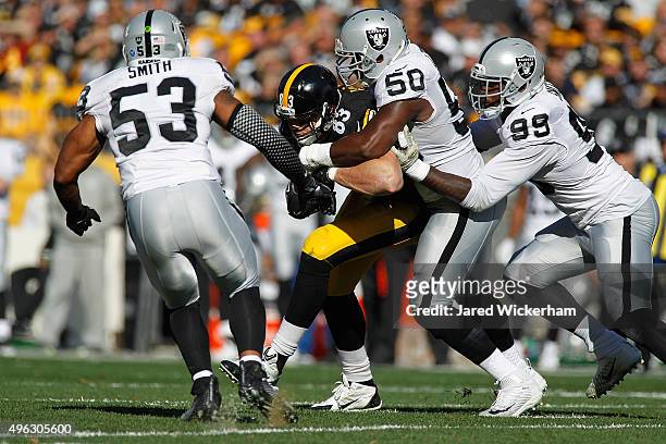 Curtis Lofton of the Oakland Raiders tackles Heath Miller of the Pittsburgh Steelers during the first half of the game at Heinz Field on November 8,...