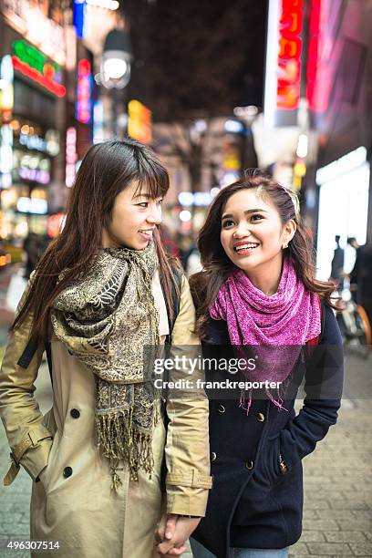 asiatic friends togetherness on tokyo embracing - teenagers japanese stock pictures, royalty-free photos & images