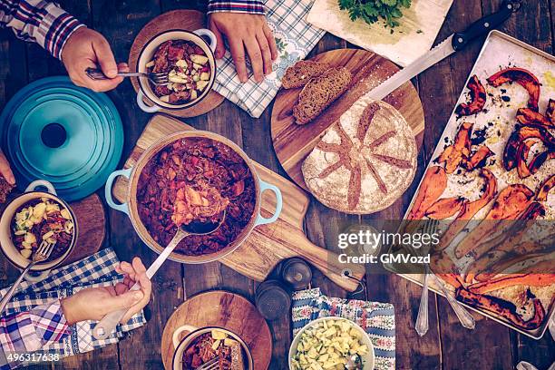 eating chili goulash stew with pumpkins and mushrooms - stew stock pictures, royalty-free photos & images