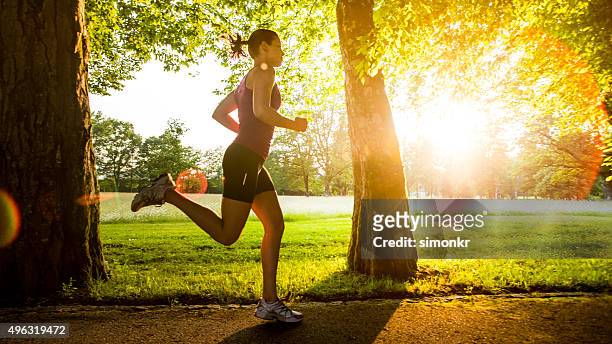 young woman jogging - jogging stock pictures, royalty-free photos & images