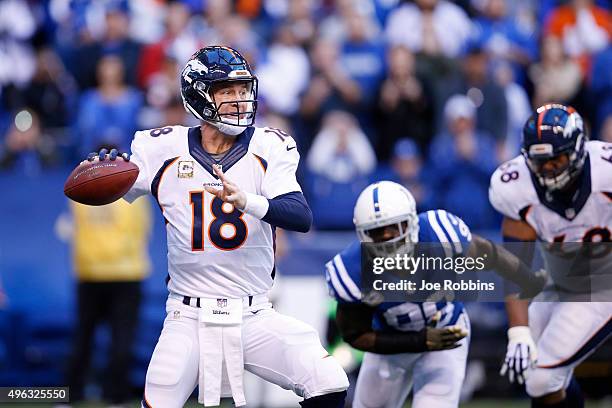 Peyton Manning of the Denver Broncos throws a pass in the first quarter of the game against the Indianapolis Colts at Lucas Oil Stadium on November...