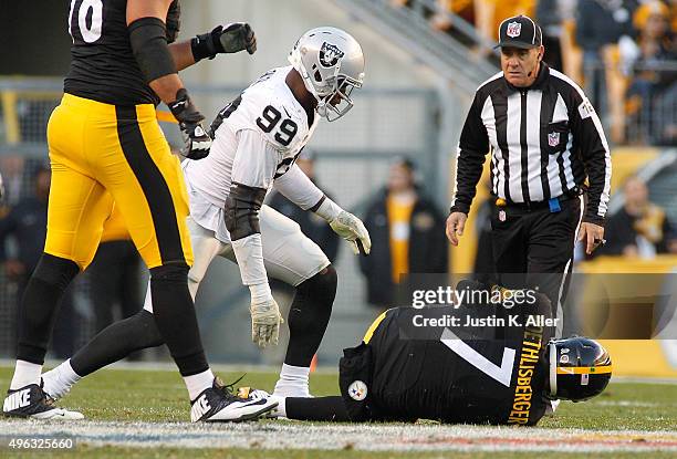 Ben Roethlisberger of the Pittsburgh Steelers is injured after being sacked by Aldon Smith of the Oakland Raiders in the 4th quarter of the game at...