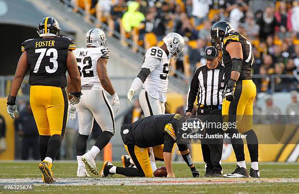 Ben Roethlisberger of the Pittsburgh Steelers is injured after being sacked by Aldon Smith of the Oakland Raiders in the 4th quarter of the game at...