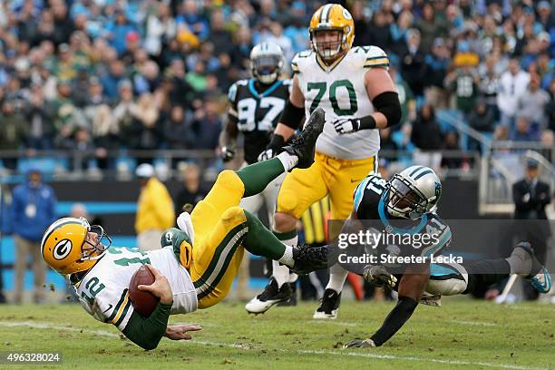 Roman Harper of the Carolina Panthers tackles Aaron Rodgers of the Green Bay Packers during their game at Bank of America Stadium on November 8, 2015...