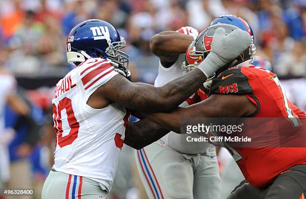 Defensive tackle Jason Pierre-Paul rushes offensive tackle Donovan Smith of the Tampa Bay Buccaneers in the first quarter at Raymond James Stadium on...