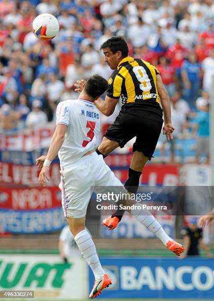 Mathias Abero of Nacional and Diego Ifran of Peñarol figh for the ball during a match between Nacional and Peñarol as part of round 12 of Apertura...