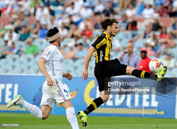 Diego Forlan of Peñarol struggles for the ball with Jorge Fucile of Nacional during a match between Nacional and Peñarol as part of round 12 of...