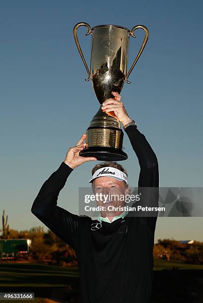 Bernhard Langer of Germany hoists the Charles Schwab Cup following the final round of the Charles Schwab Cup Championship on the Cochise Course at...