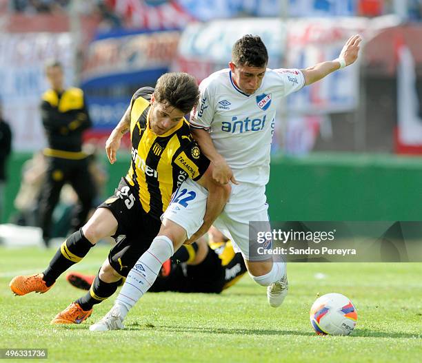 Nahitan Nandes of Peñarol struggles for the ball with Luis Espino of Nacional during a match between Nacional and Peñarol as part of round 12 of...