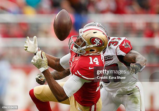 Jerome Simpson of the San Francisco 49ers catches the ball and then is hit by Ricardo Allen of the Atlanta Falcons and then Phillip Adams of the...